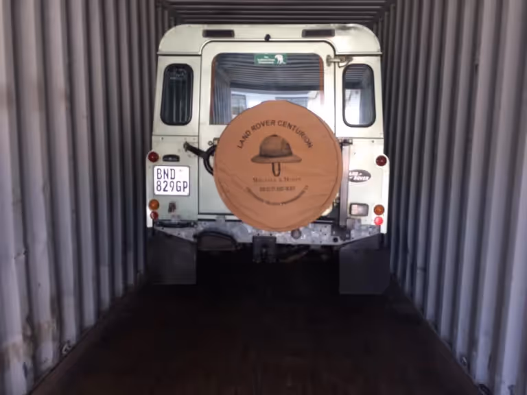 Land Rover Defender loaded in a shipping container