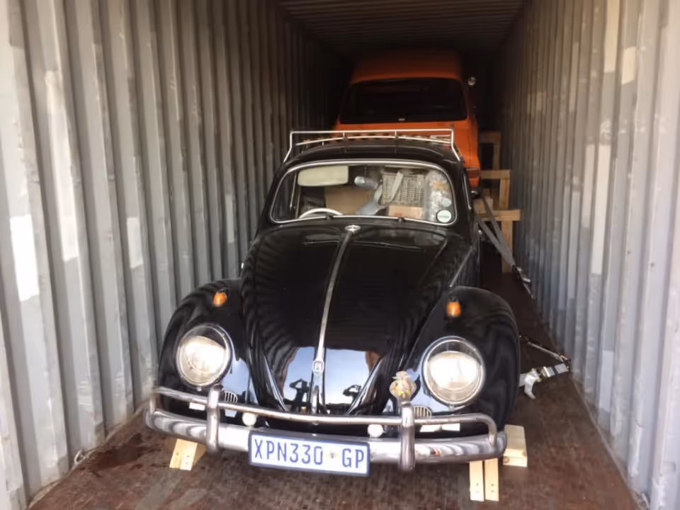 Classic Volkswagen Beetle secured inside a shipping container